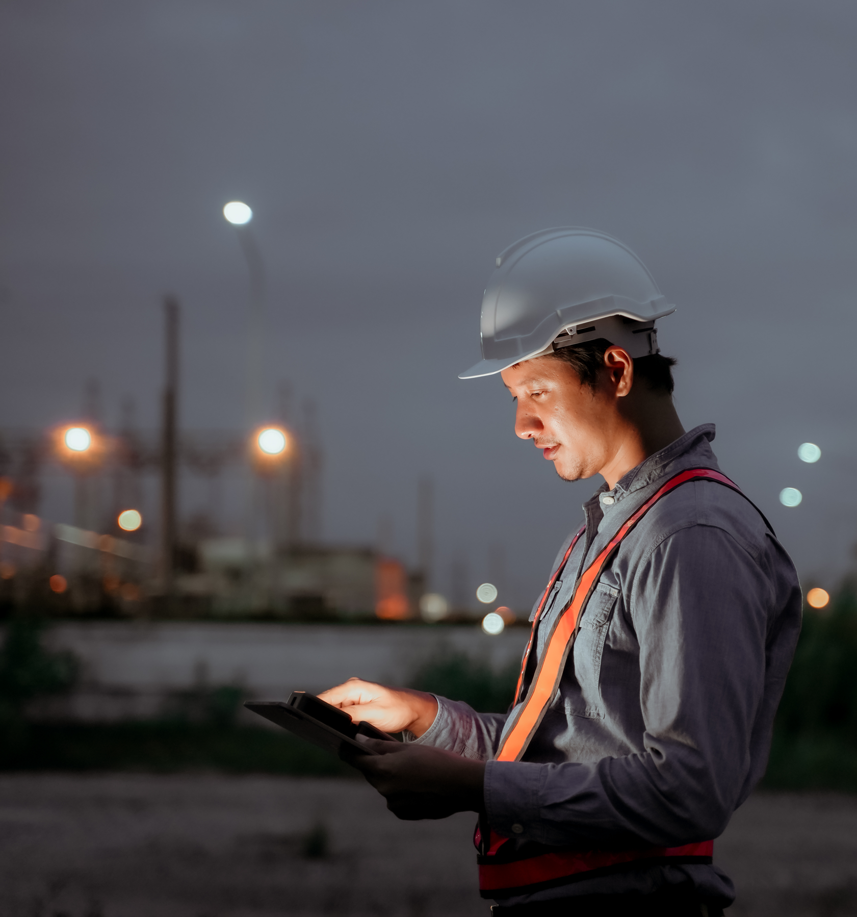 Oil and gas industry plant engineer using a digital tablet for inspections